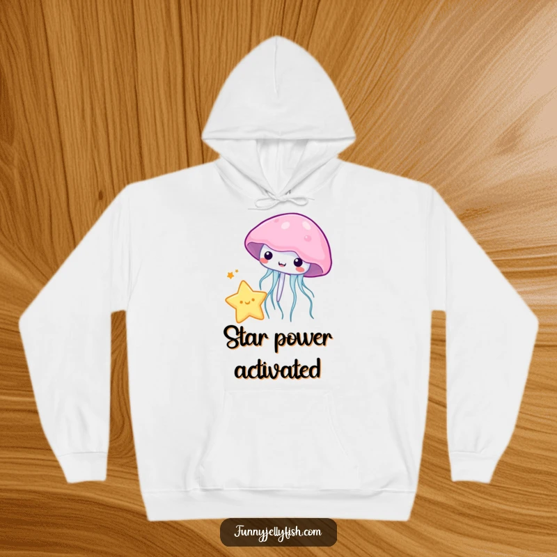 Funny kawaii jellyfish playfully bouncing a tiny star with its bell, featured on this soft and cozy hoodie.